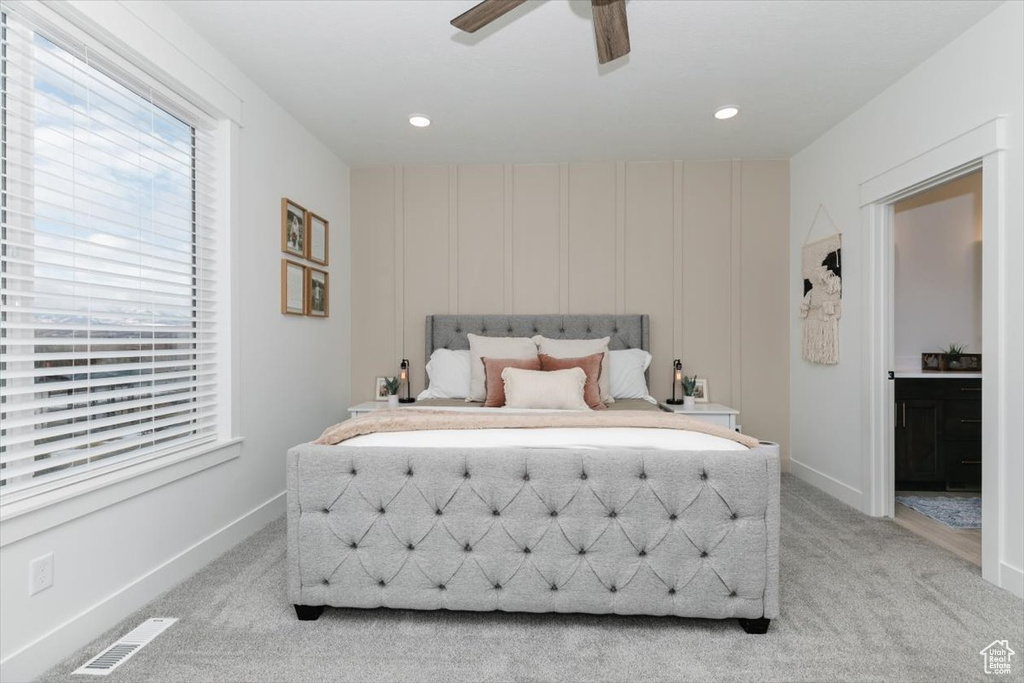 Bedroom featuring light carpet, visible vents, and baseboards