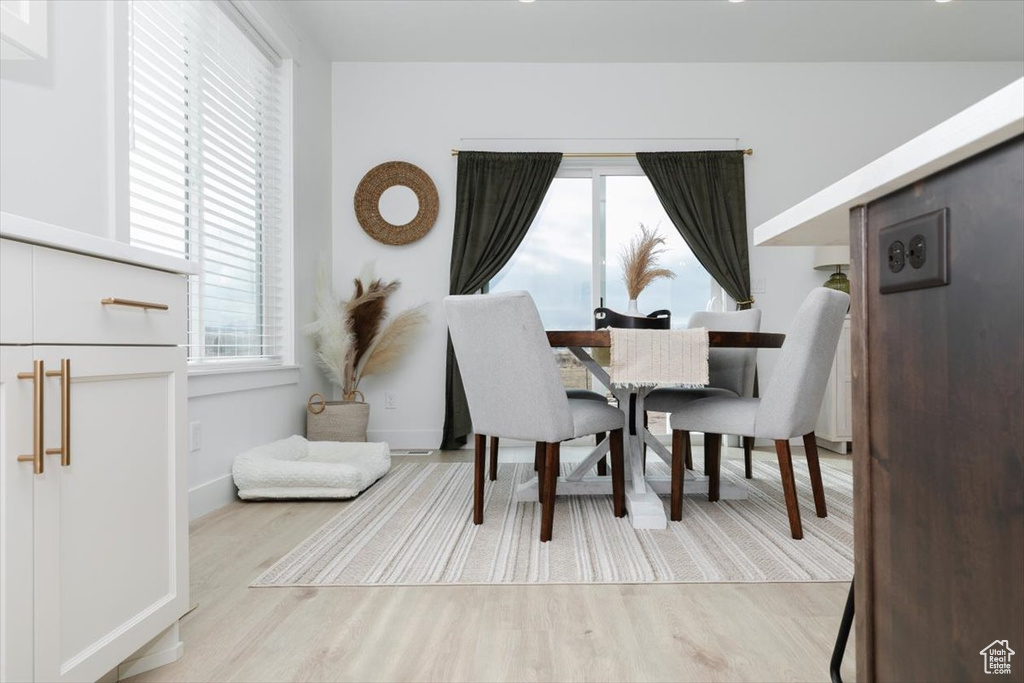 Dining space featuring light wood-style floors and baseboards