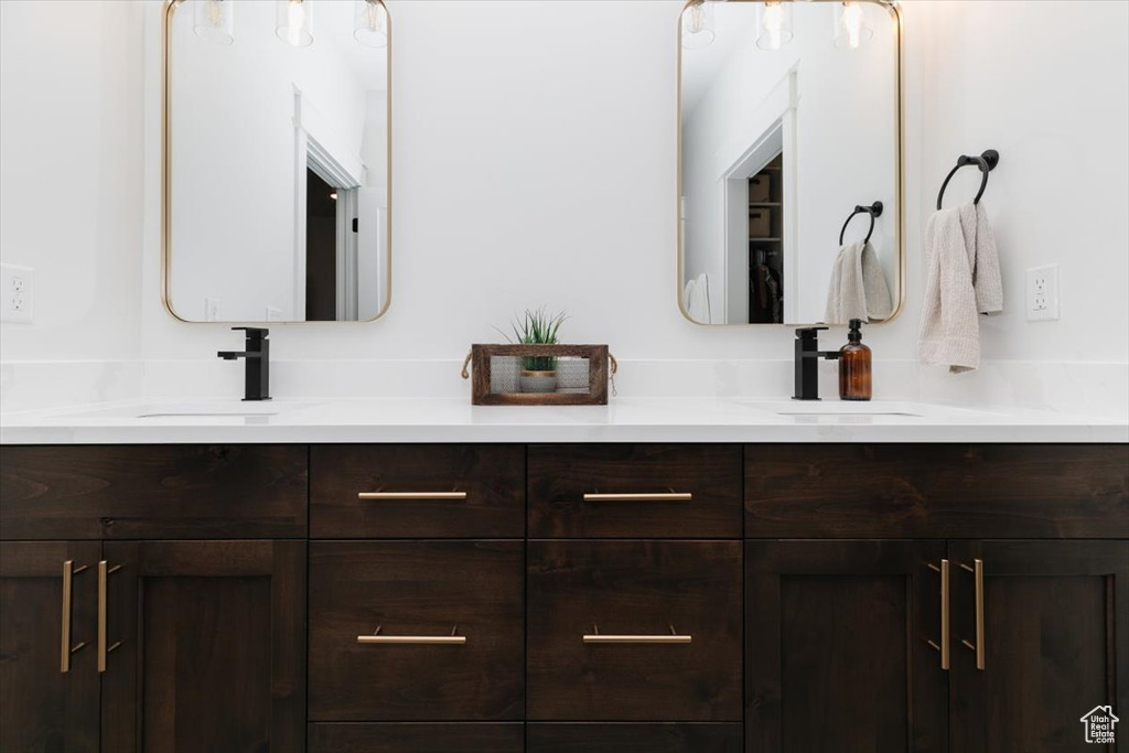 Bathroom featuring double vanity and a sink