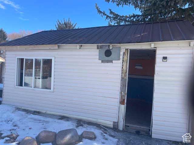 Entrance to property with a standing seam roof and metal roof