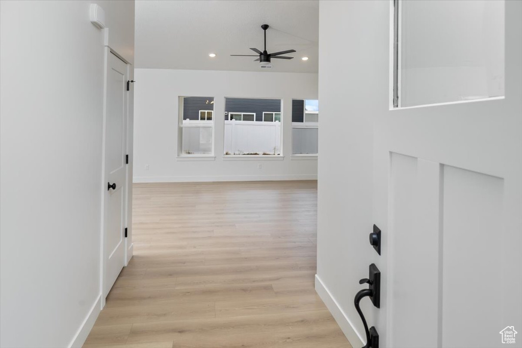 Corridor with baseboards, light wood-type flooring, and recessed lighting