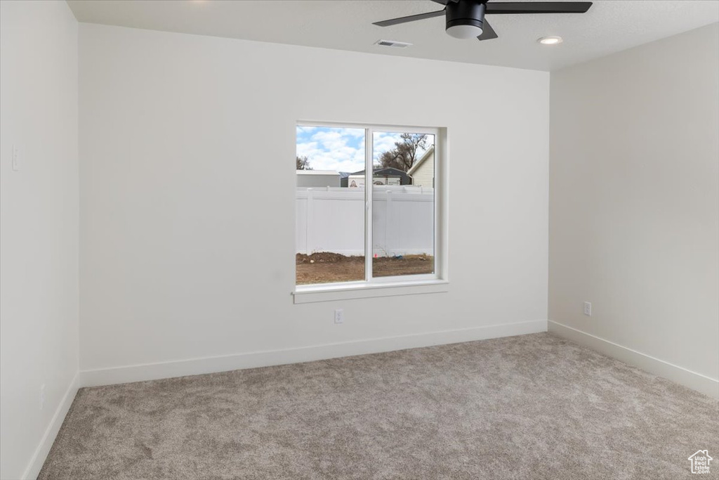 Empty room with recessed lighting, carpet, visible vents, and baseboards