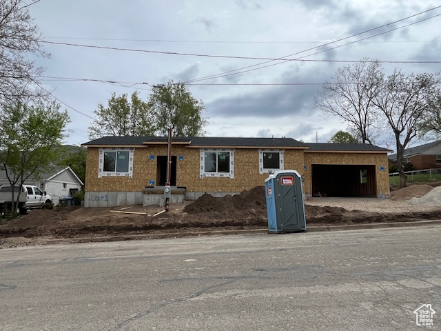 View of front facade with driveway and a garage