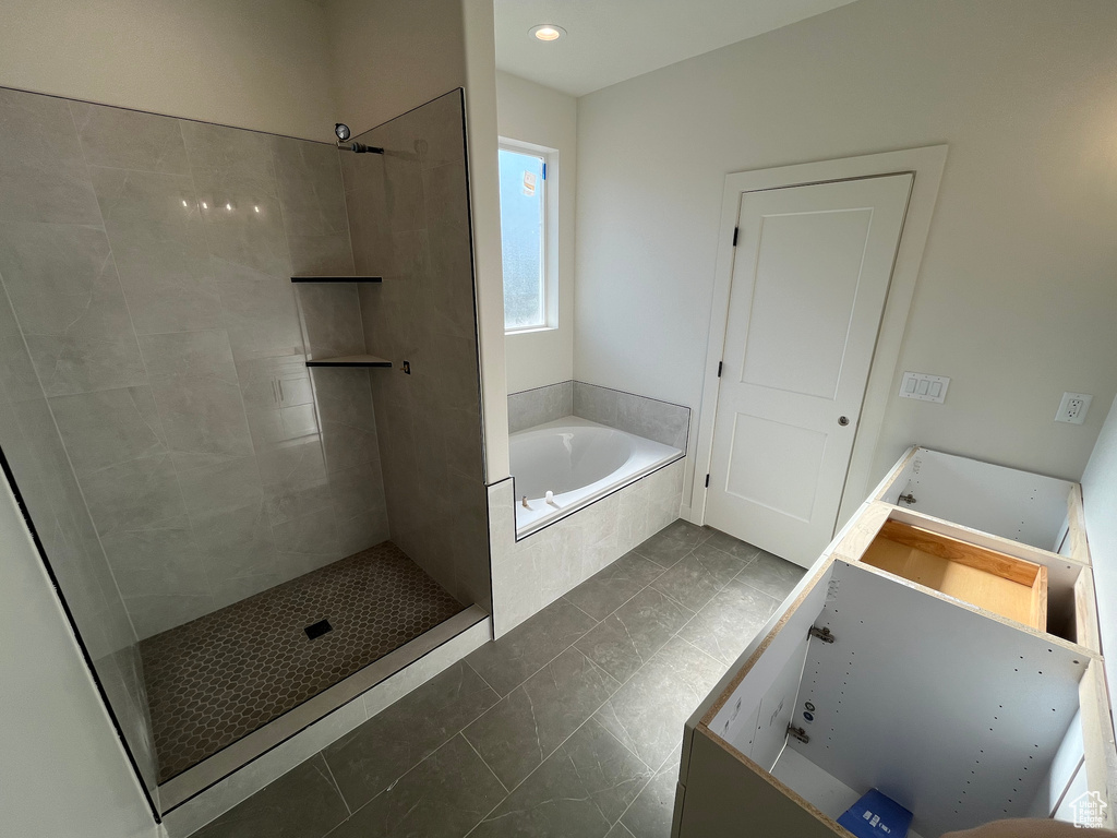 Full bath with a tile shower, a bath, vanity, tile patterned flooring, and recessed lighting