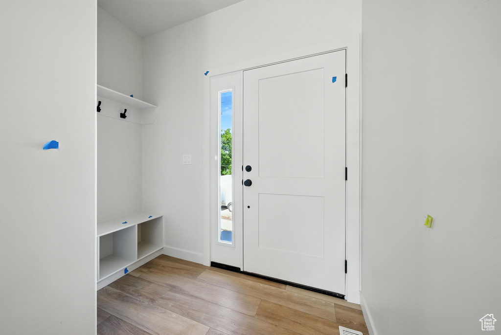 Mudroom featuring wood finished floors and baseboards