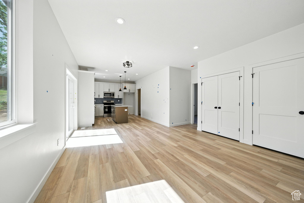 Unfurnished living room featuring light wood-style floors and recessed lighting