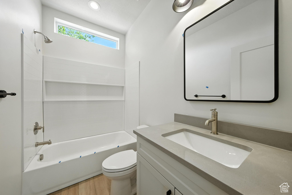 Bathroom with vanity,  shower combination, and wood finished floors