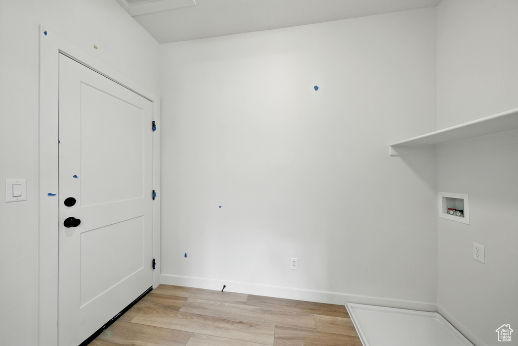 Laundry room with washer hookup and light wood-type flooring