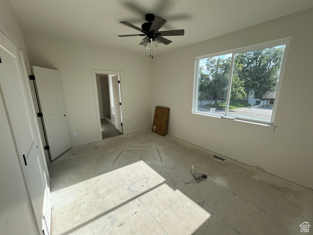 Unfurnished bedroom featuring ensuite bathroom and ceiling fan