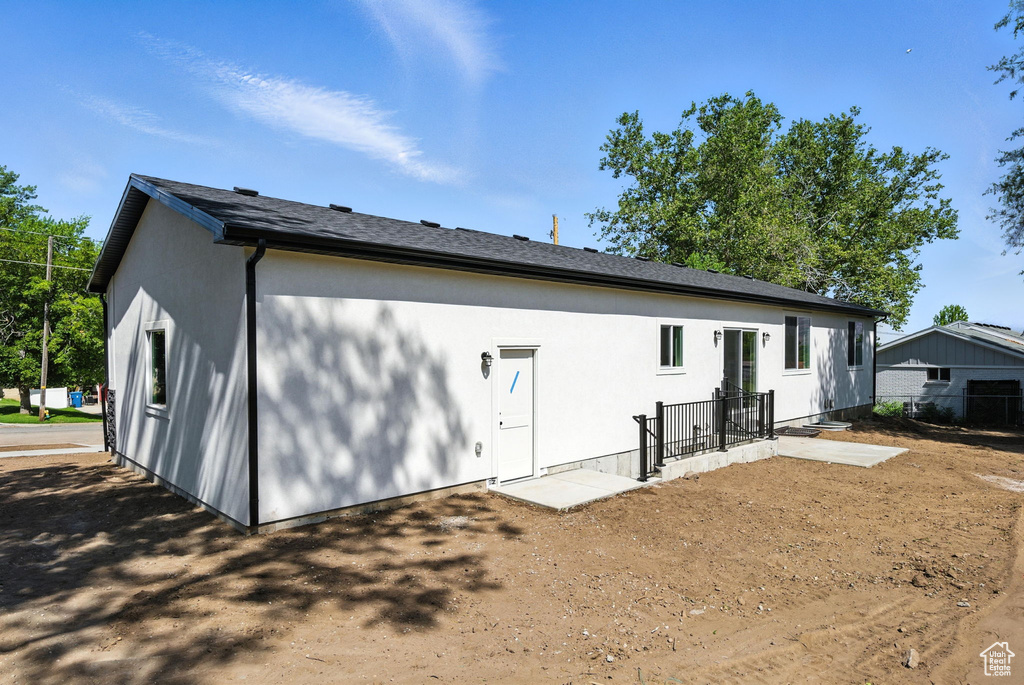 Back of house featuring stucco siding