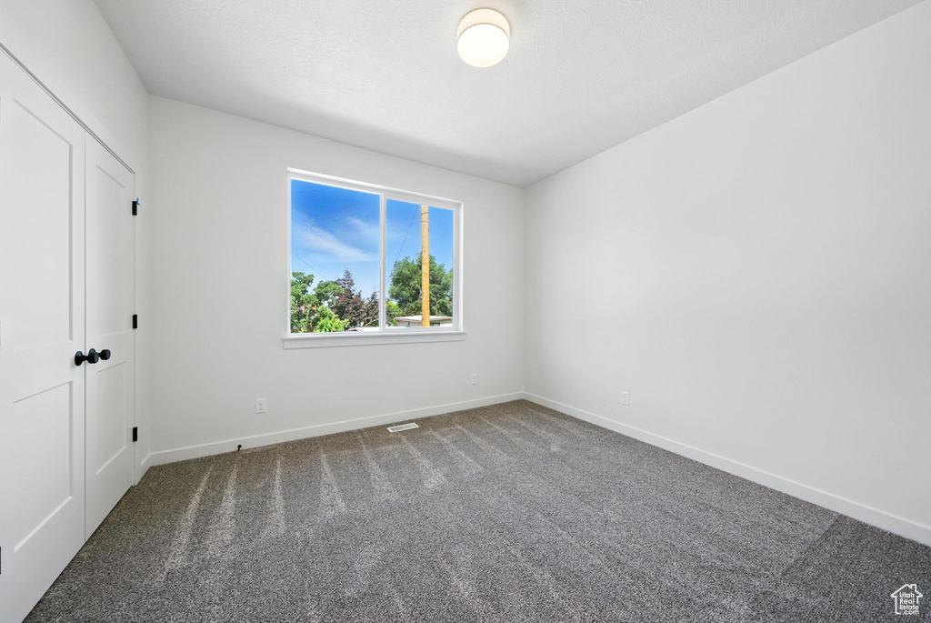 Spare room with carpet flooring and baseboards