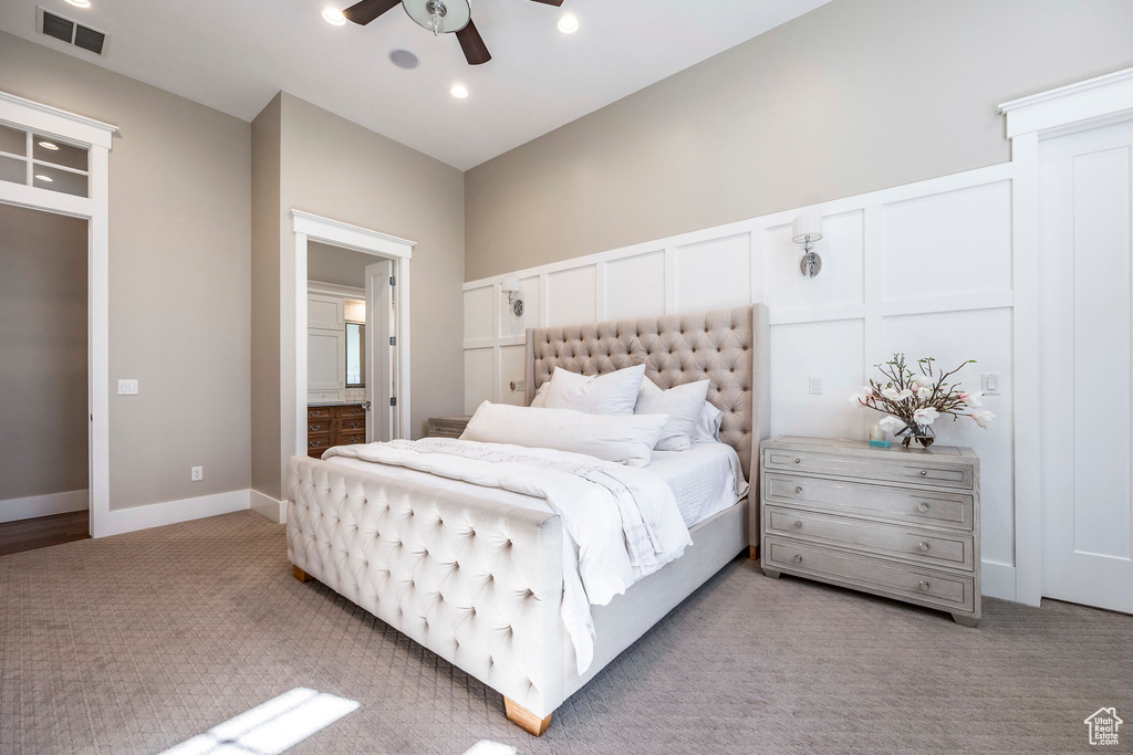 Bedroom featuring carpet flooring, connected bathroom, recessed lighting, ceiling fan, and a decorative wall