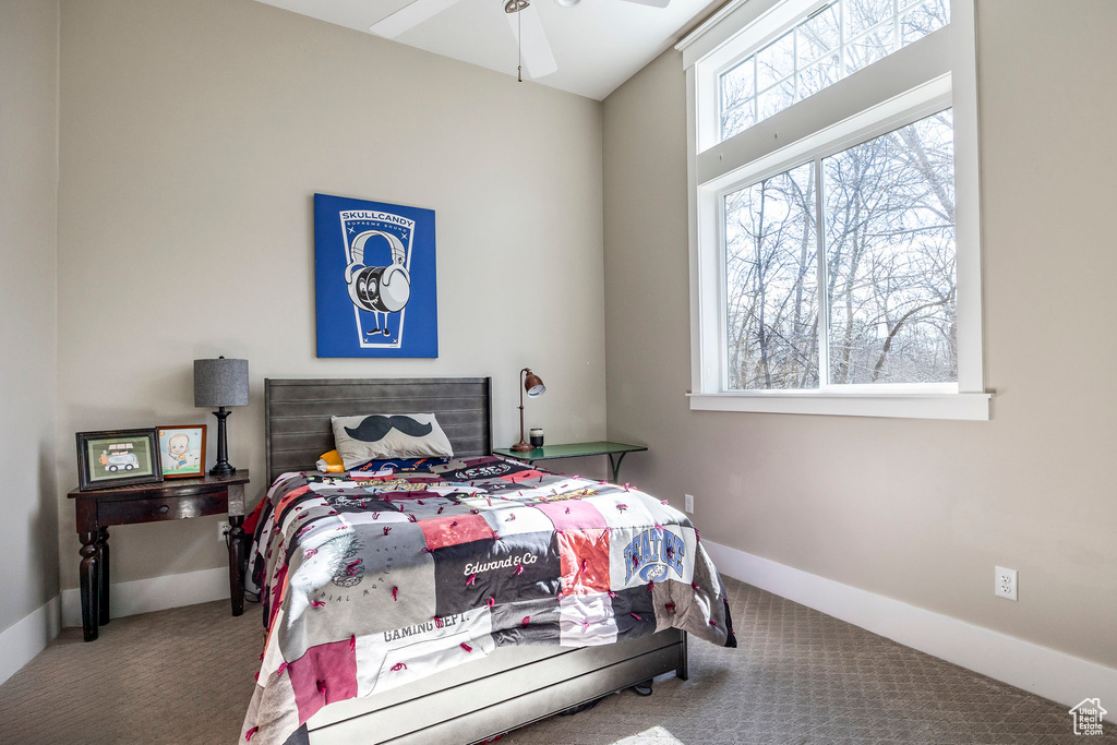 Bedroom with carpet, baseboards, and ceiling fan