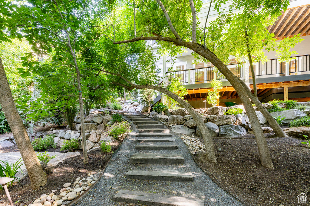 View of yard featuring stairs and a wooden deck