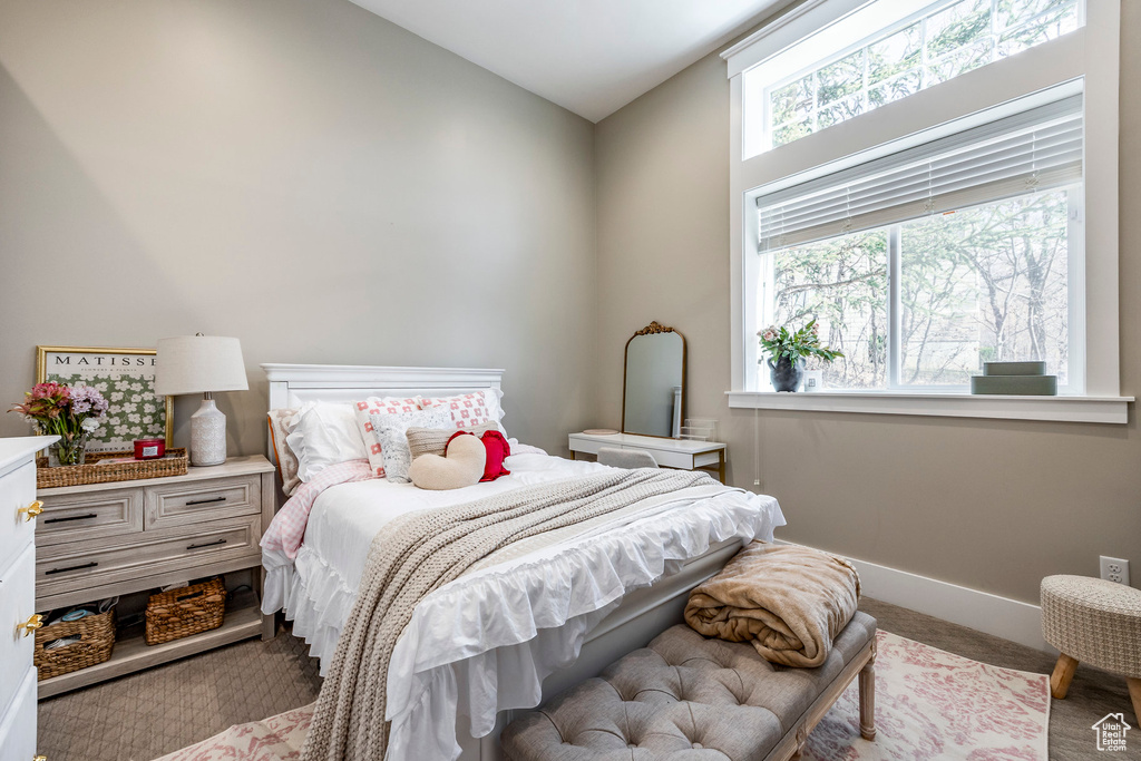 Carpeted bedroom featuring baseboards
