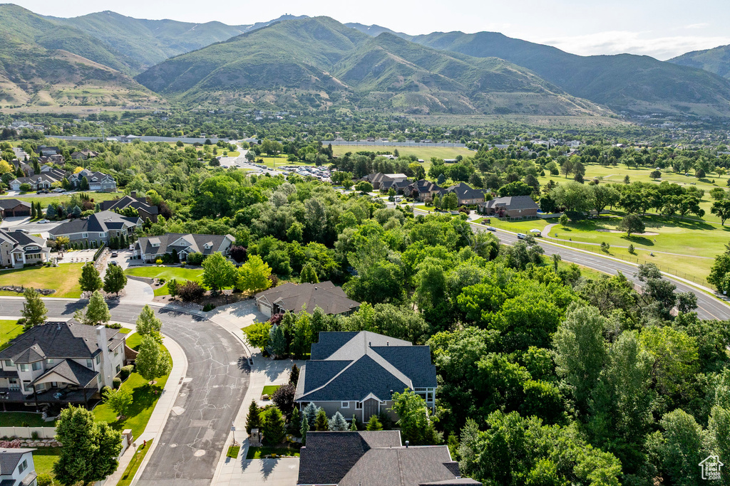 Aerial perspective of suburban area featuring a mountain backdrop