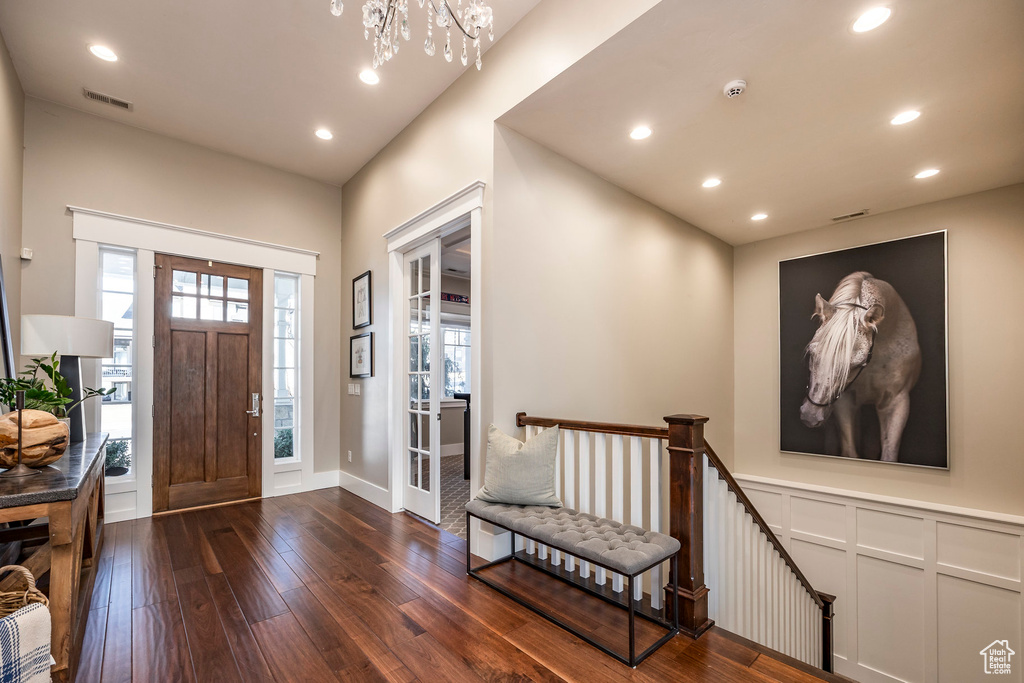 Foyer entrance featuring dark wood-type flooring, recessed lighting, a chandelier, and baseboards