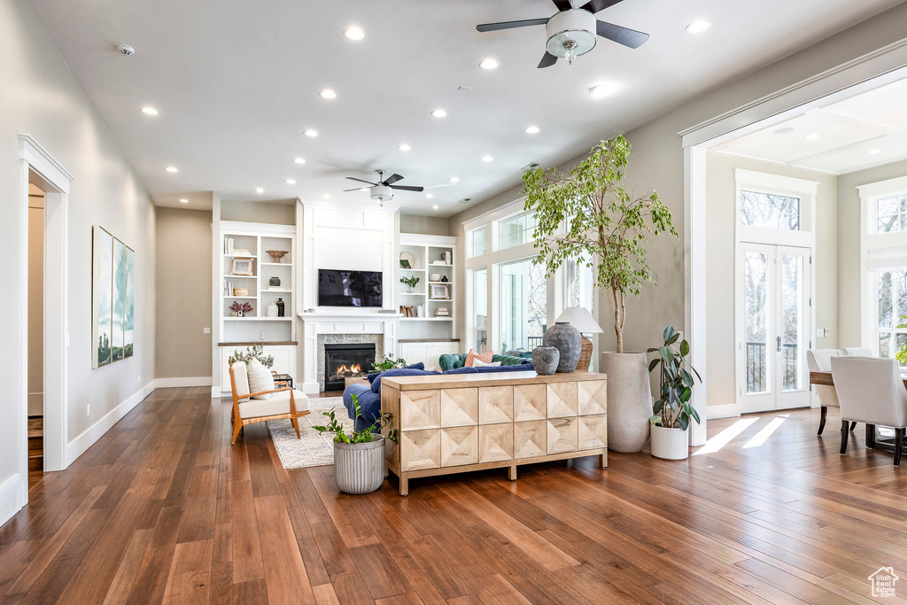 Living area featuring ceiling fan, dark wood finished floors, a premium fireplace, and recessed lighting
