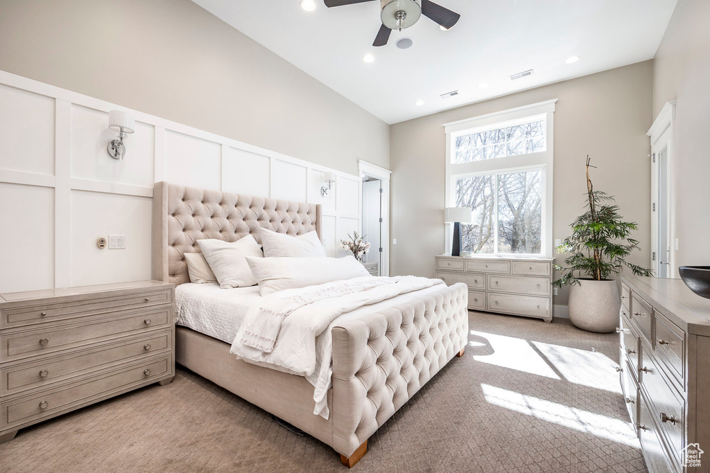 Bedroom with light carpet, recessed lighting, and a ceiling fan