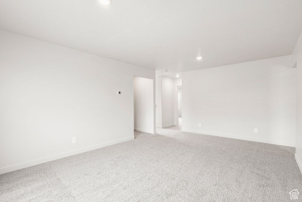 Unfurnished room featuring baseboards, light colored carpet, and recessed lighting