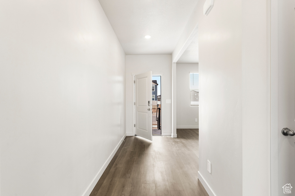 Hallway featuring baseboards and dark wood-style floors