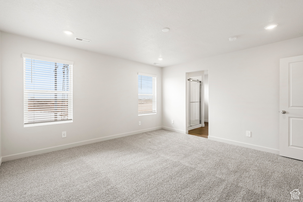 Unfurnished bedroom featuring baseboards, carpet flooring, visible vents, and recessed lighting