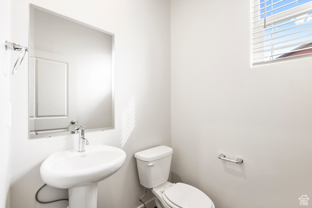 Half bathroom featuring a sink and toilet