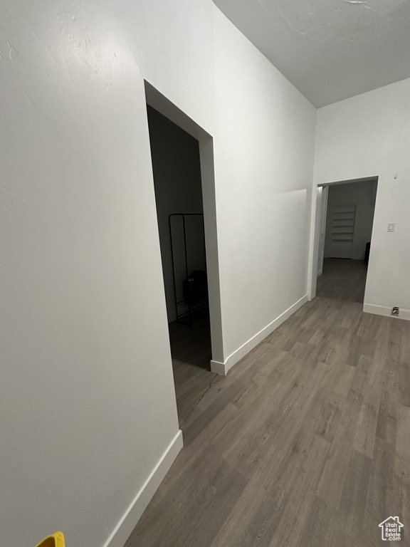 Hall featuring baseboards and wood finished floors