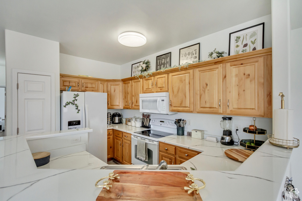 Kitchen with white appliances and light countertops