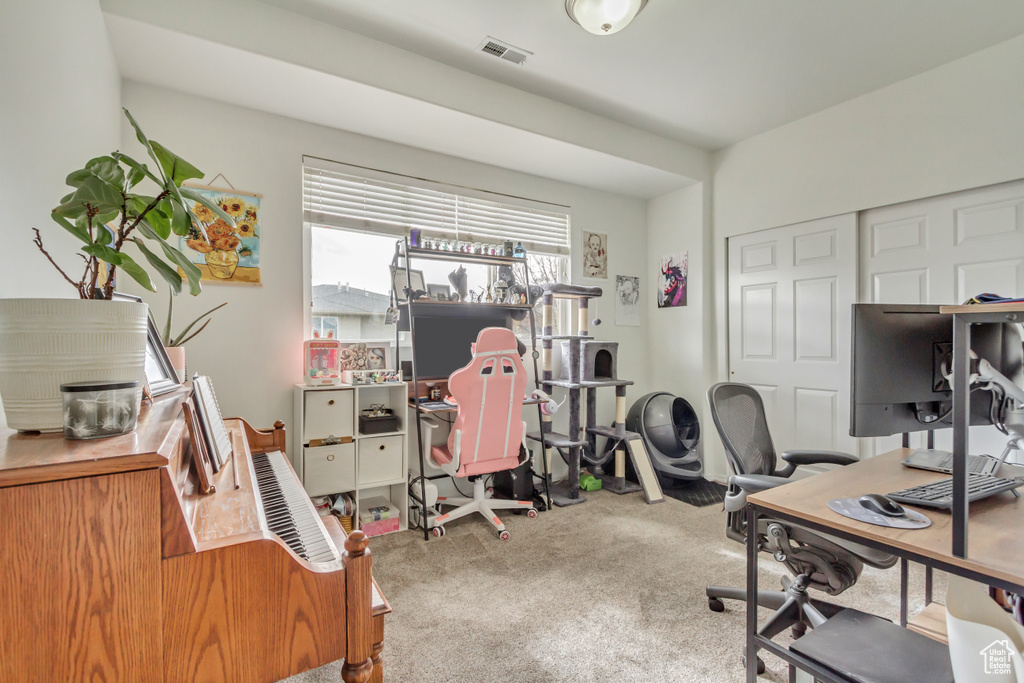 Home office with visible vents and carpet flooring