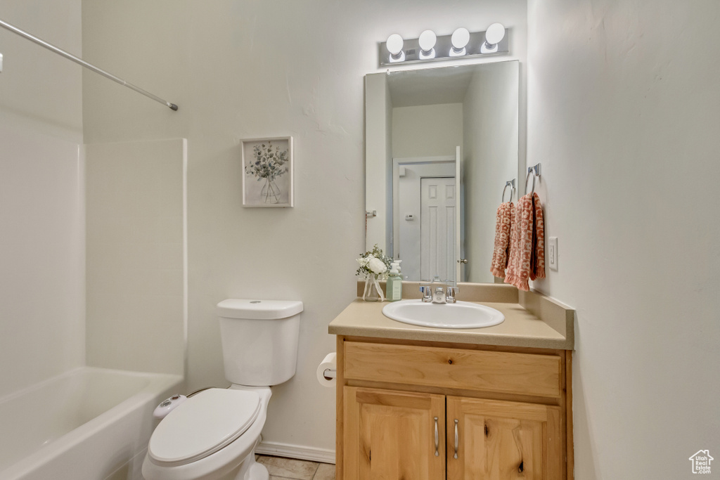 Bathroom with toilet, bathtub / shower combination, and vanity