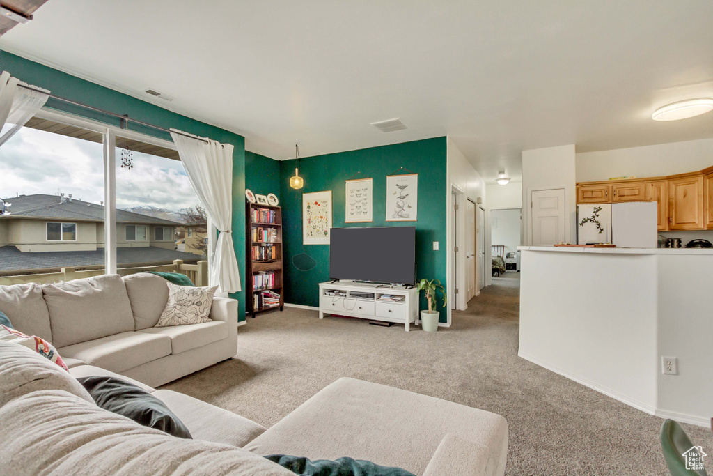 Living room featuring light carpet, baseboards, and visible vents