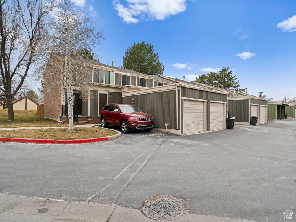 View of front of house with a garage and an outdoor structure