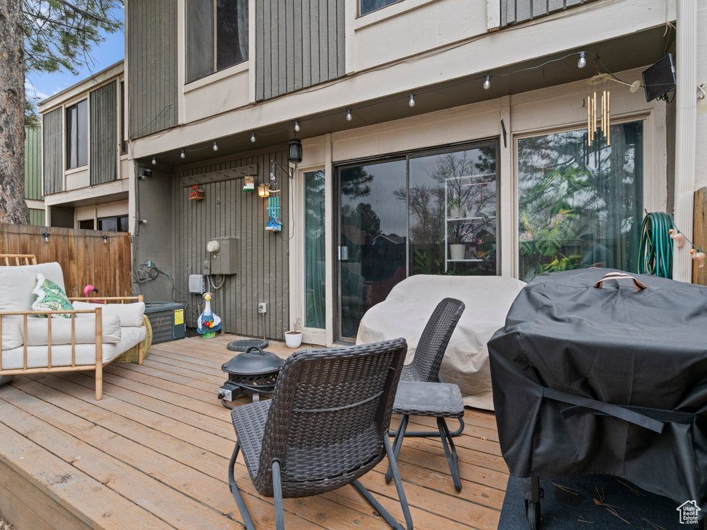 Wooden deck featuring area for grilling