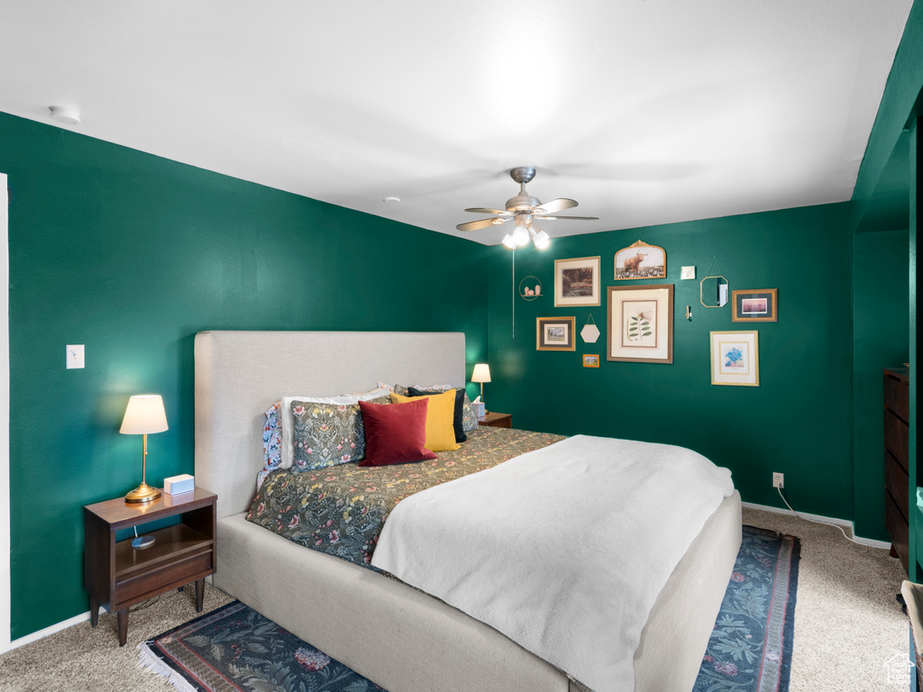 Bedroom with carpet floors, ceiling fan, and baseboards