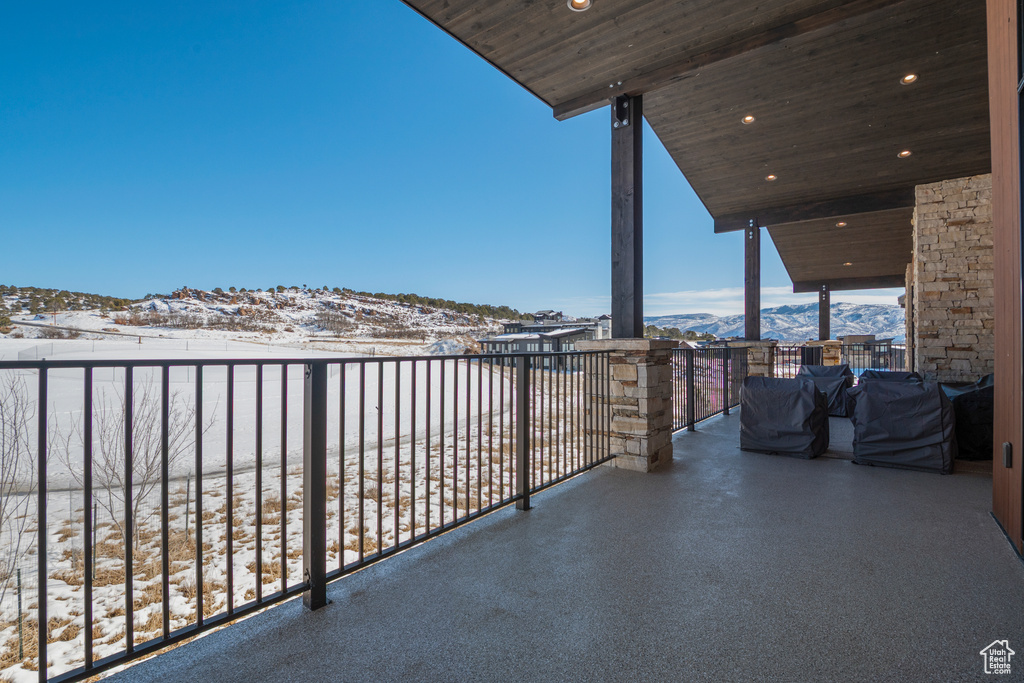 Snow covered back of property featuring a mountain view