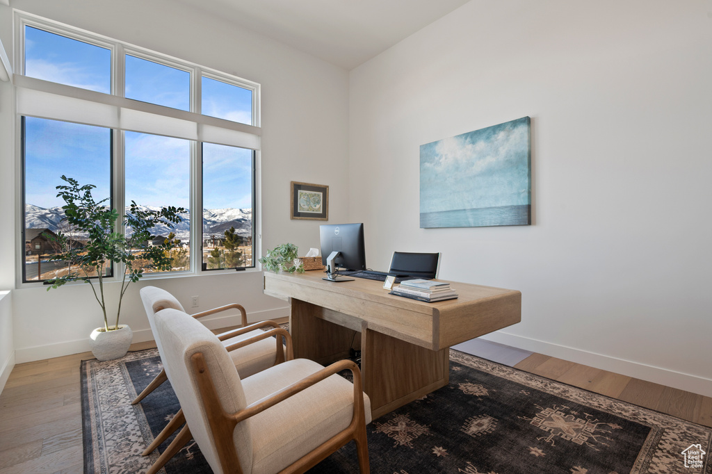 Home office featuring baseboards and wood finished floors