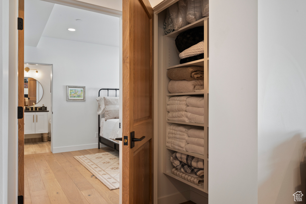 Hall with light wood-type flooring, baseboards, and recessed lighting