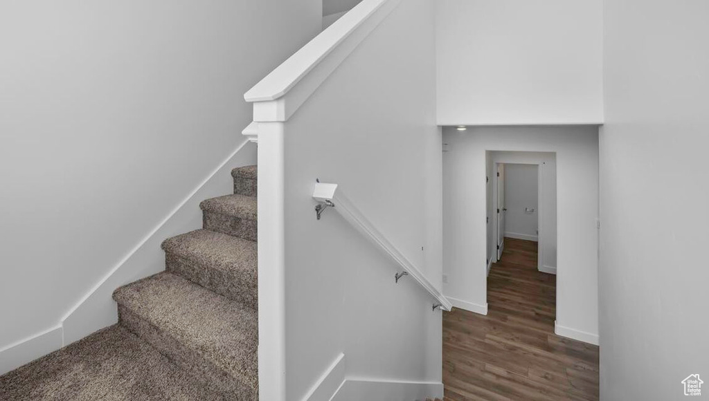 Stairway with baseboards and wood finished floors