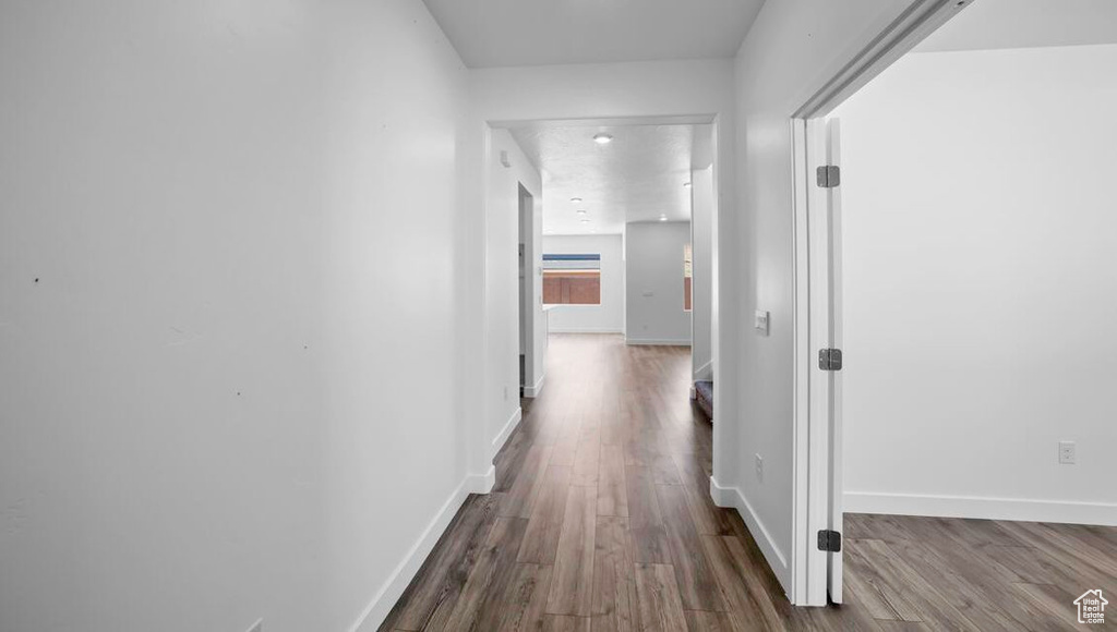 Corridor featuring wood finished floors and baseboards