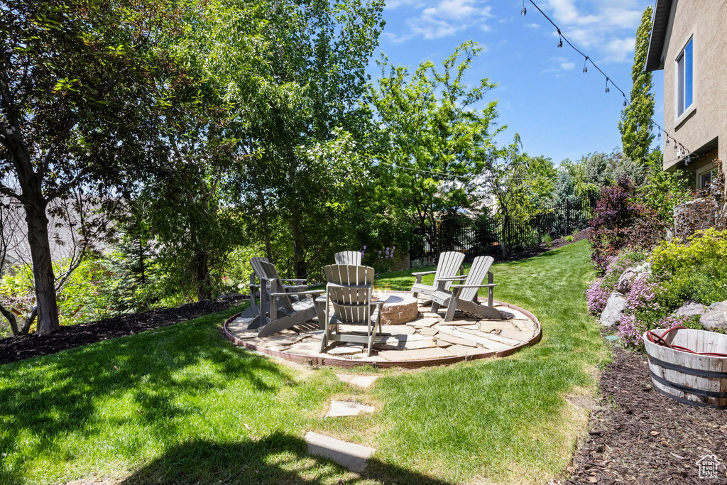 View of yard featuring a patio and a fire pit