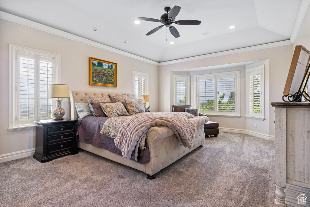 Carpeted bedroom featuring recessed lighting, a raised ceiling, ornamental molding, a ceiling fan, and baseboards