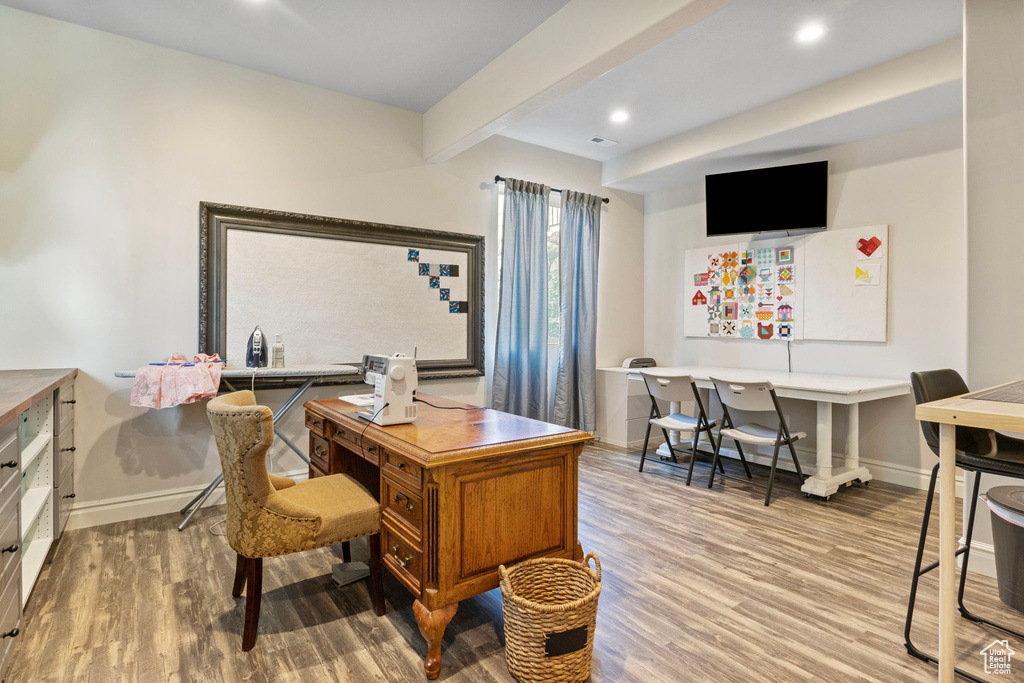 Office space with recessed lighting, beam ceiling, baseboards, and wood finished floors