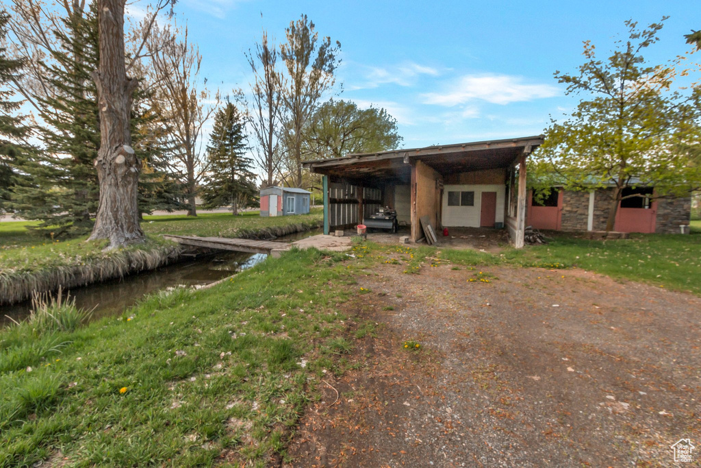 View of front of property featuring an outdoor structure and a shed
