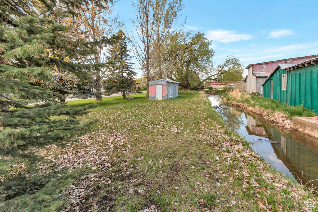 View of yard with a storage shed and an outbuilding