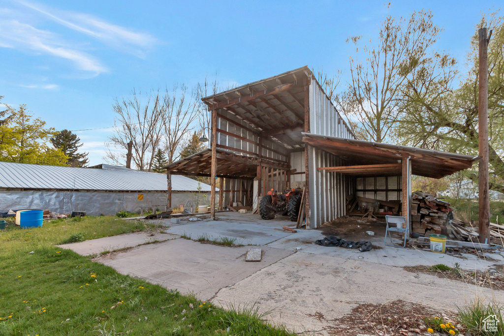 Exterior space featuring a pole building and an outdoor structure
