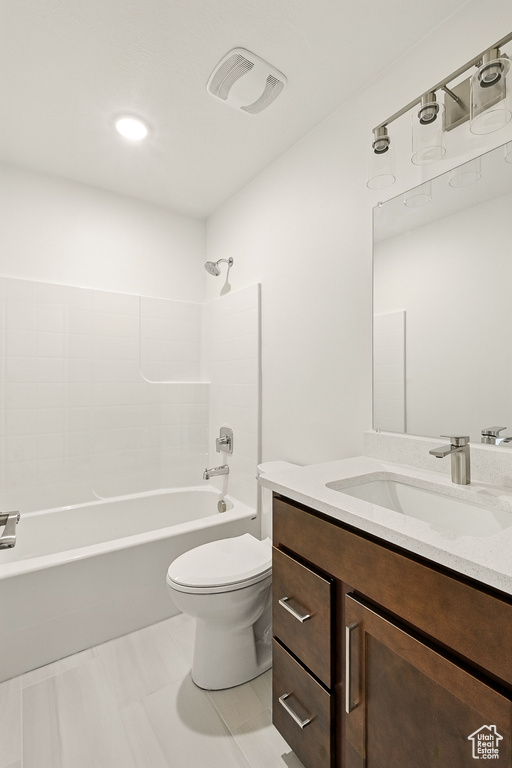 Full bathroom with toilet, vanity, and shower / tub combination