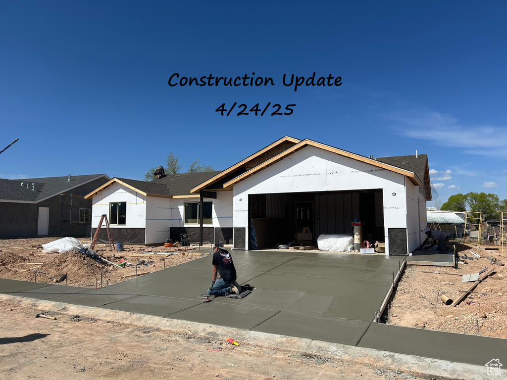 View of front of house featuring an attached garage and driveway