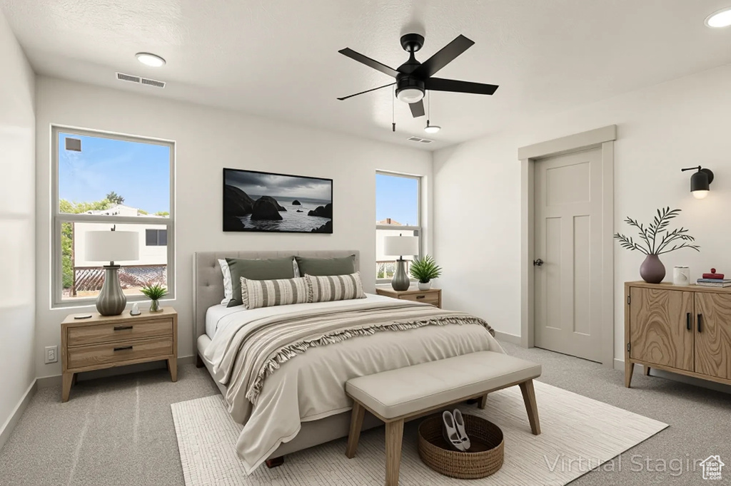 Bedroom with light colored carpet, baseboards, a ceiling fan, and recessed lighting