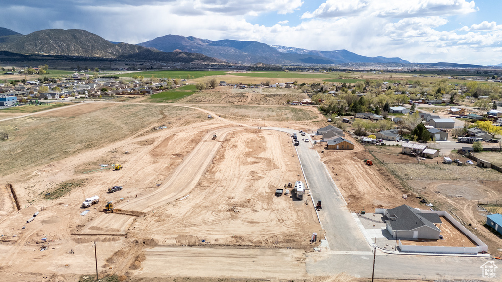 Aerial view of sparsely populated area with a mountain backdrop and nearby suburban area